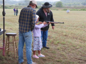 young girl shooting muzzleloader